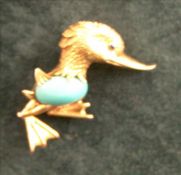 An 18 ct gold turquoise set brooch Formed as a duck centred with a turquoise cabochon. 3.5 cms high.