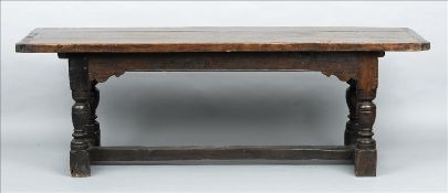 An 18th century and later oak refectory table The cleated plank top above a shaped frieze,