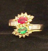 An 18 ct gold ruby, emerald and diamond set dress ring Generally in good condition.