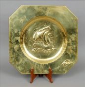 An Arts & Crafts brass charger The deep rim decorated with a shell, the dish centre with a