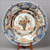 A large 19th century Imari charger The broad rim decorated with birds amongst foliage with a central