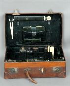 A Victorian leather gentleman’s travelling case The interior with various silver and ivory fitments,