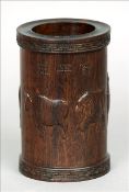 A late 19th/early 20th century Chinese carved hardwood brush pot The cylindrical body carved with