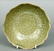 A 19th century Chinese celadon dish The interior decorated with floral scrollwork. 15 cms