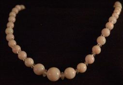 An opaline bead necklace With carved crystal roundel spacers. Approximately 40 cms long. Some