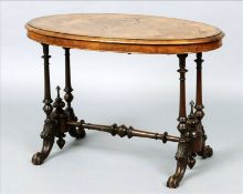 A Victorian walnut centre table The parquetry inlaid and crossbanded oval top above a plain frieze