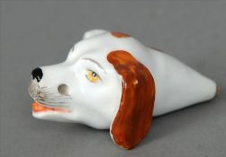 A 19th century English porcelain whistle Naturalistically modelled and painted as a hounds’ head,