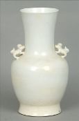A Chinese porcelain white glaze twin handled vase Of baluster form, the handles formed as shi-shi,