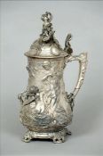 An Art Nouveau WMF style lidded tankard The hinged lid surmounted with Bacchic putto, the main