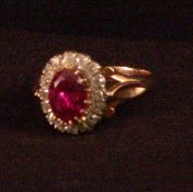 An unmarked gold diamond and pink sapphire cluster ring The central old cushion cut stone