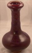 A Chinese porcelain vase Of baluster form with tall ribbed neck and purple mottled glaze. 16 cms