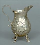 An Edwardian silver cream jug, hallmarked London 1903, maker’s mark indistinct The scrolling