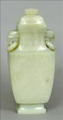 A Chinese carved jade twin handled vase and cover Decorated with floral and foliate sprays, the twin