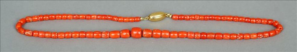 A coral bead necklace Formed from ascending sized coral beads and with an unmarked yellow metal