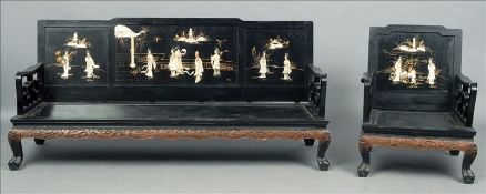 A Chinese lacquered three piece suite Each panelled back decorated with figures and pagodas above