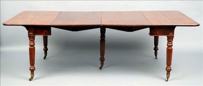 An early 19th century mahogany concertina action extending dining table The hinged rectangular top