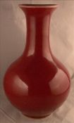 A Chinese sang de boeuf porcelain vase Of baluster form. 23 cms high.