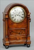 A 19th century mahogany and rosewood cased mantel clock The domed top above a silvered dial with