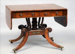 A 19th century rosewood sofa table The line inlaid and crossbanded twin flap rounded rectangular top