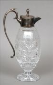 An Edwardian silver plate mounted cut glass claret jug The hinged lid and scrolling handle above the