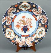A 19th century Japanese Imari charger The border decorated with floral vignettes and phoenix, the