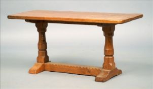 A carved oak coffee table by Robert “Mouseman” Thompson of Kilburn The adzed rounded rectangular top