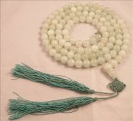 A Chinese pale jade necklace 106 cms long.