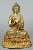 An Antique Sino-Tibetan gilt bronze Buddha Typically modelled seated in the lotus position. 20 cms