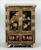 An early 20th century Chinese lacquered table cabinet The brass bound square top decorated with