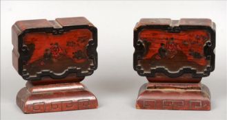 A pair of Chinese lacquered bookends Each decorated with figures in a garden, standing on a carved