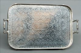 A Victorian silver plated galleried tray The scroll cast carrying handles above a pierced gallery