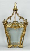 A rococo style gilt brass handing hall lantern The scroll cast four glass body of tapering form.