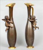 A pair of 19th century patinated spelter ewers Each of slender ovoid form with an applied cherub.