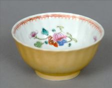 A Chinese porcelain tea bowl Of fluted form, the interior decorated with floral sprays, the exterior