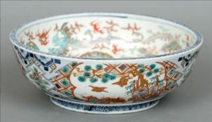 A 19th century Japanese Imari bowl Decorated with various mythical beasts and centred with a