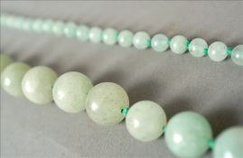 A string of pale jade beads Approximately 46 cms long. Some slight fritting and general wear.