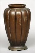 A 19th century Chinese patinated bronze vase The squat neck rim above the segmented tapering body,