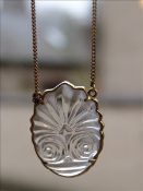 An 18 ct gold mounted carved rock crystal pendant by Ilias Lalaounis Carved with a stylised frond,