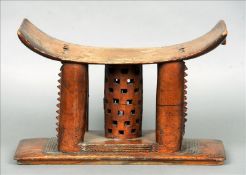 A 19th/20th century African tribal stool, probably Ashanti The pierced seat supported on a central