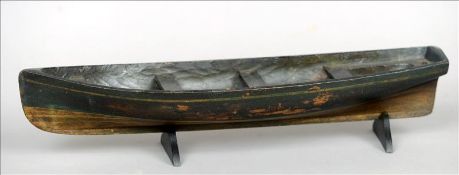An 19th century model of a Thames river boat Of naive dug out construction, the hull with green