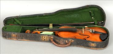 A 19th century violin Of typical form, with label to interior stamped Copy of Maggini, cased and