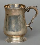 A Georgian silver tankard, possibly hallmarked London 1768, maker’s mark of IK The waisted