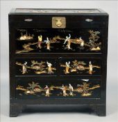 An Oriental lacquered cabinet The hinged lid above three drawers with overall inset figural