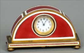 A small Art Deco enamel decorated bronze clock The red guilloche enamel decorated demi-lune case