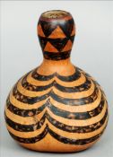An African gourd flask, possibly a Zulu milk pot 18 cms high. Split to neck, some general wear.