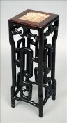 A 19th century Chinese carved hardwood urn stand The marble inset top above scroll carved