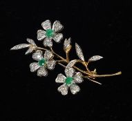 An 18 ct gold diamond and emerald brooch Formed as a floral spray. 5.5 cms high. Generally in good