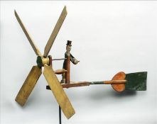 A late 19th/early 20th century painted wooden whirligig Formed as a gentleman wearing a top hat