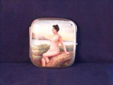 An early 20th century silver and enamel cigarette case The front decorated with a nude lady, the