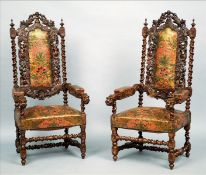 A pair of 19th century leather upholstered carved oak open armchairs The padded back carved with